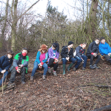 Green Volunteers relax on tree