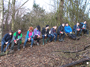 Green Volunteers relax on tree